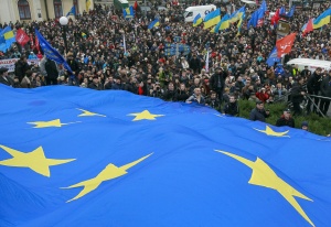 Protesters hold a EU flag as they take part in a rally to support EU integration in central Kiev